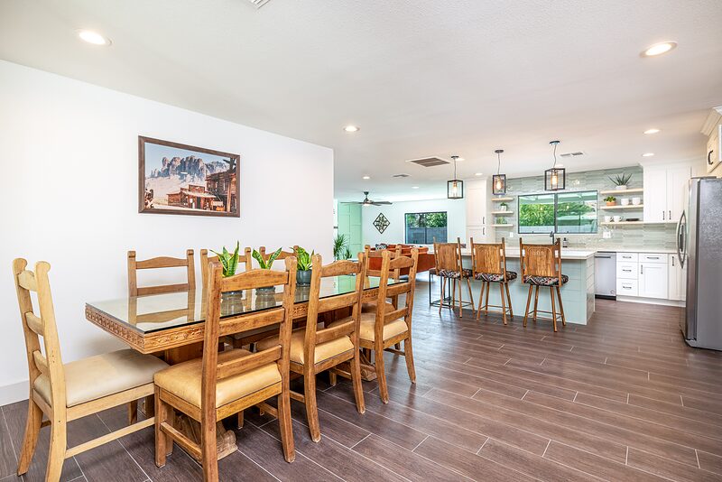 Dining table seating eight, open to the kitchen beyond