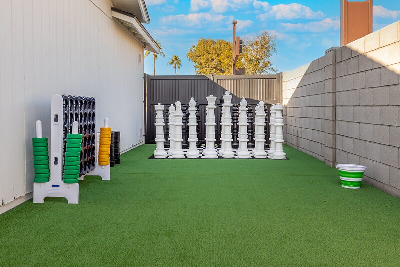 Giant lawn chess set and giant Connect Four on a turf side yard